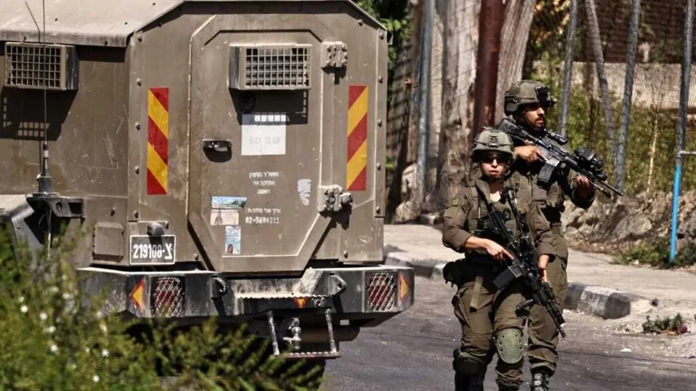 Israeli soldiers walk down a road during a raid on Ramallah city in the occupied West Bank on 16 September 2025 (Zain Jaafar/AFP)