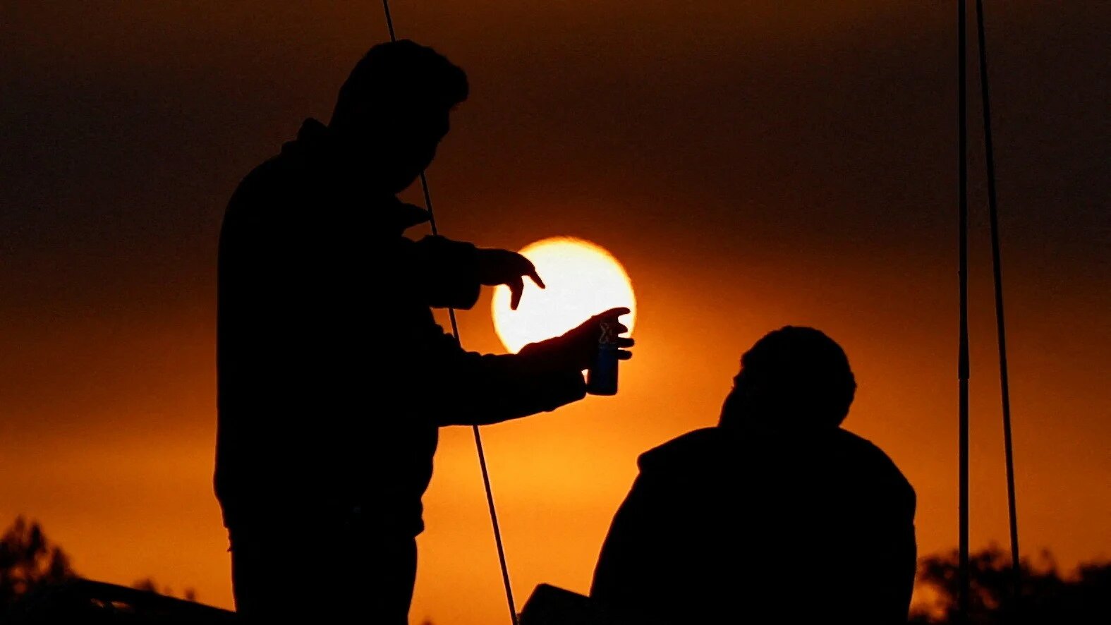 Israeli soldiers talk on top of a military vehicle on the Israeli side of the boundary with Gaza (Reuters/Clodagh Kilcoyne)