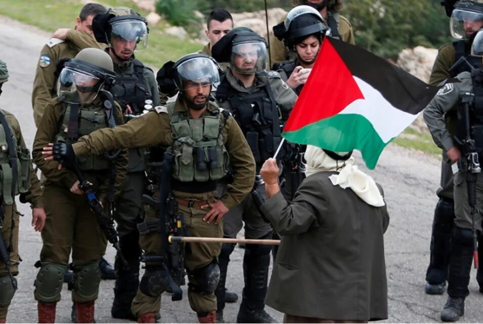 A Palestinian protests against Israeli settlements 