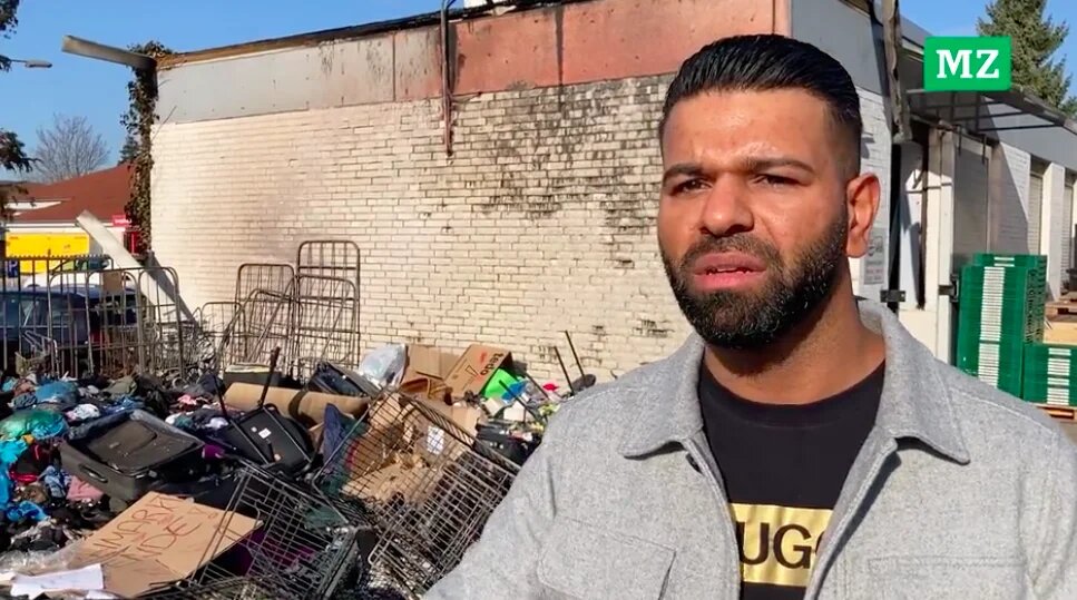 Video footage shows two arsonists burning the clothes, with Raj saying two Turkish flags had also been thrown into the fire (Screengrab)