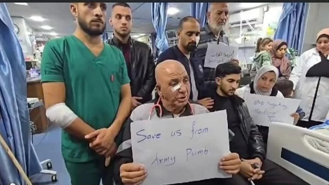Dr Saeed Joudeh, who was previously injured, holds a sign pleading for the world to save the people of Gaza on 10 December 2024, just two days before he was killed in Gaza (Social media)