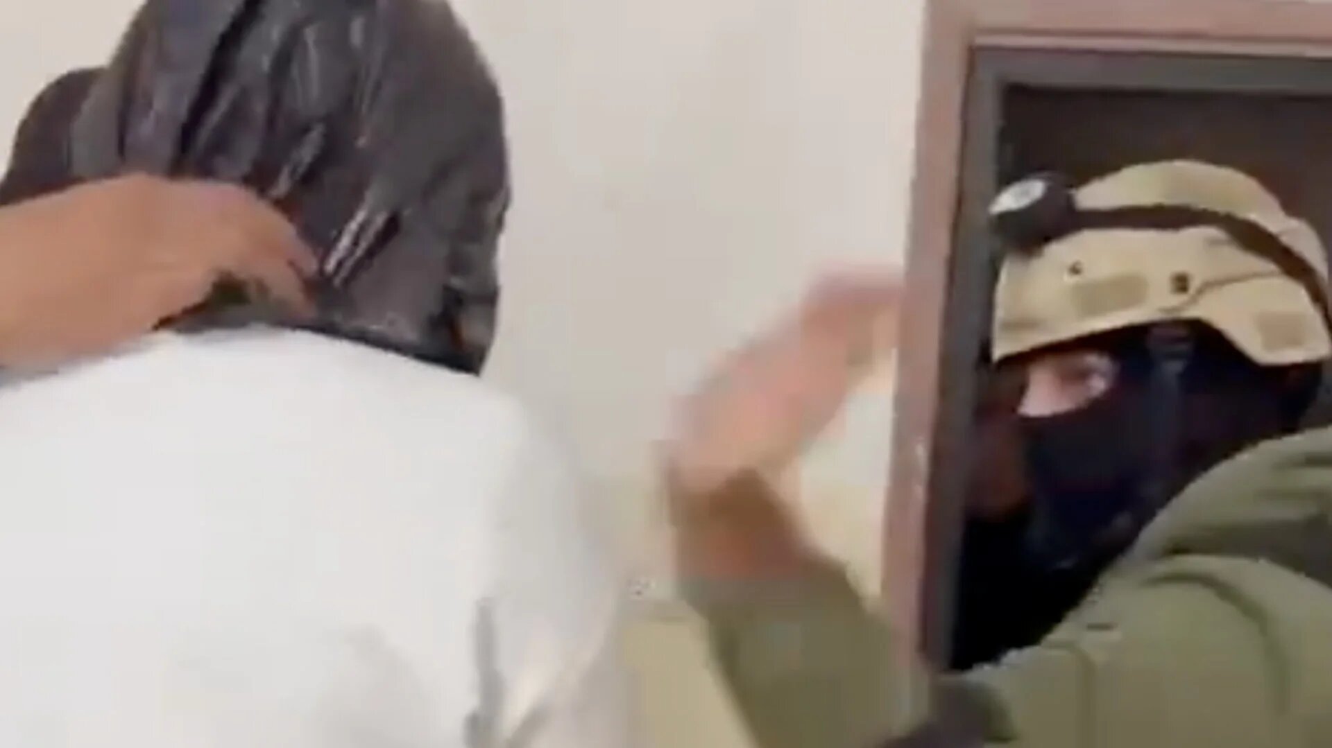 Face-covered Palestinian security forces slapping a detainee in the face while his head is covered with a plastic bag (Screengrab/X)