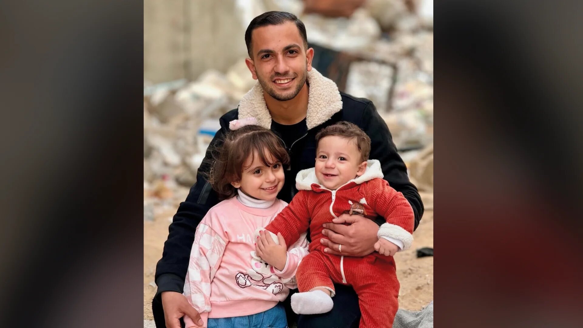 Al Jazeera correspondent Anas al Sharif holding his two children, daughter Sham (L) and son Salah (R)