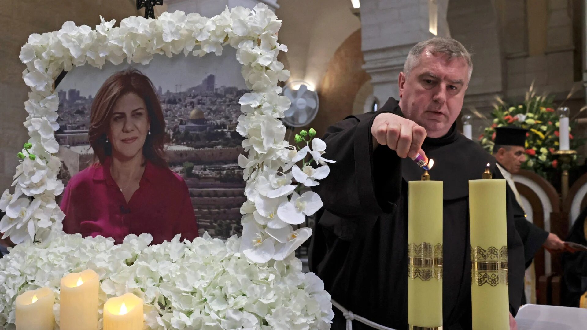 Priests pray during a mass held for al-Jazeera reporter Shireen Abu Akleh at the Church of the Nativity, Bethlehem, 16 May 2022. (AFP)