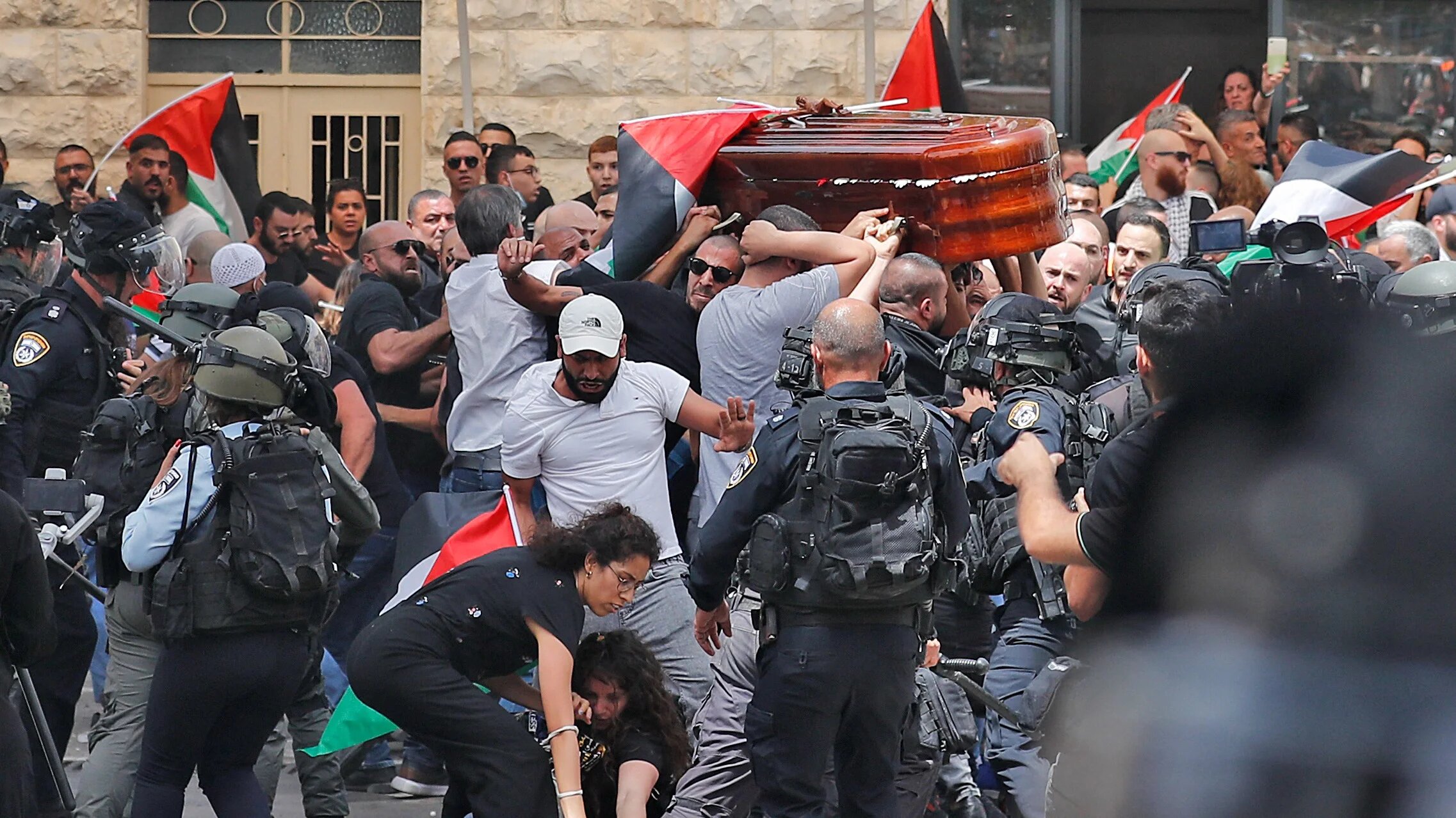 Mourners carrying the casket of Al-Jazeera journalist Shireen Abu Akleh out of a hospital, before being transported to a church and then her resting place, in Jerusalem, on May 13. (AFP)