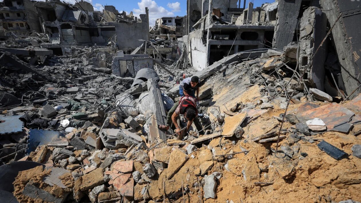 Palestinians search for casualties trapped under the rubble on Thursday at the site of an Israeli air strike that hit a house the previous day in Shujaiya, Gaza City (Dawoud Abu Alkas/Reuters)