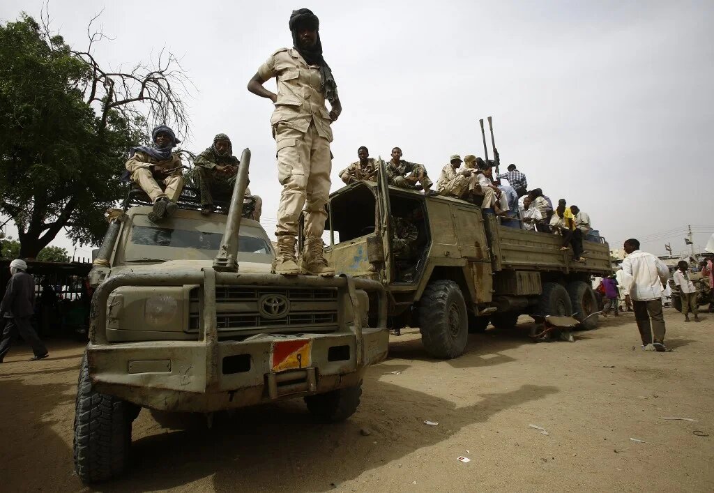 Fighters from the Sudanese Rapid Support Forces sit in vehicles in the city of Nyala, in south Darfur, on 3 May 2015 (Ashraf Shazly/AFP)