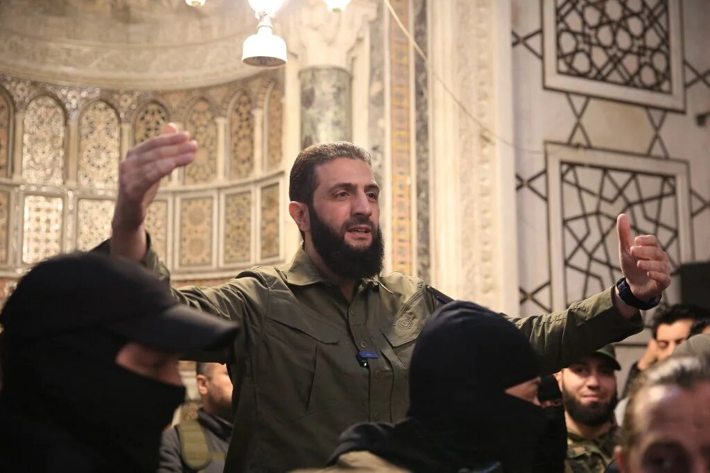 Ahmed al-Sharaa, leader of Syria’s Hay’at Tahrir al-Sham (HTS), addresses a crowd at the Umayyad Mosque in Damascus on 8 December 2024 (AFP/Aref Tammawi)