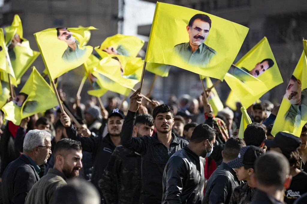 File Photo: Protesters march with yellow flags showing the face of Abdullah Ocalan, the leader of the Kurdistan Worker's Party (PKK) -- currently prison in Turkey, during a demonstration Qamishli in northeastern Syria on December 6, 2022. (Delil SOULEIMAN / AFP)