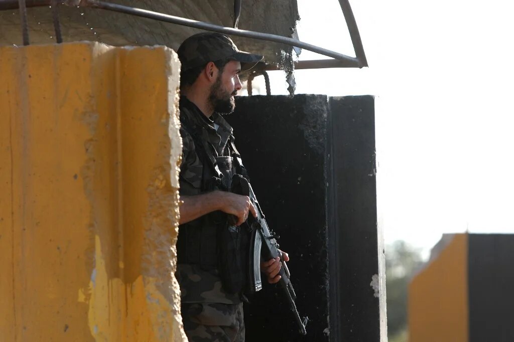 A fighter in a faction of the Turkey-backed Syrian National Army mans a checkpoint in the Tal Battal area near al-Bab city on 26 September 2023 (Bakr Alkasem/AFP)