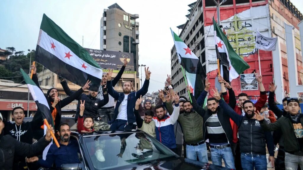 Syrians in the northern Lebanese city of Tripoli celebrate the fall of Bashar al-Assad, 9 December 2024 (Fathi al-Masri/AFP)