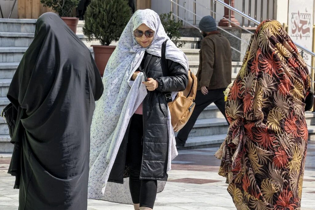 People walk outside at the Emamzadeh Saleh mosque in Tajrish square in northern Tehran on 12 March 2024, the first day of the holy fasting month of Ramadan in Iran (Atta Kenare/AFP)