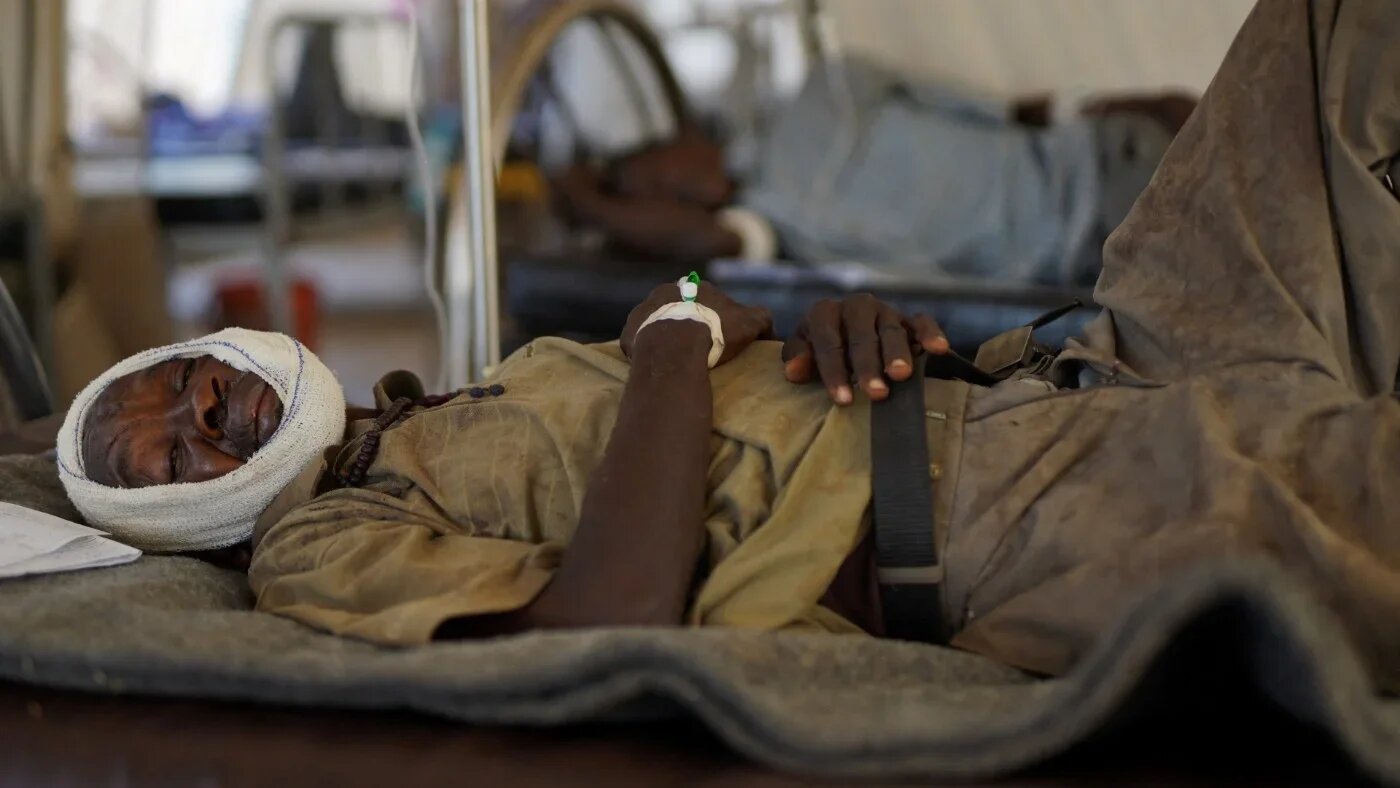 An injured Sudanese man who fled violence in el-Fasher receives treatment at a makeshift clinic run by Doctors Without Borders (MSF) in Tawila, North Darfur, Sudan on 3 November 2025 (Mohamed Jamal/Reuters)