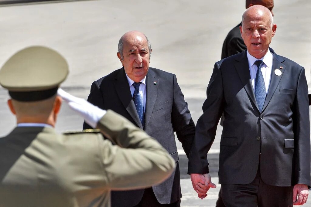 Tunisia's President Kais Saied (right) receives Algeria's President Abdelmadjid Tebboune upon the latter's arrival at Tunis-Carthage International Airport in April 2024 (Fethi Belaid/AFP)