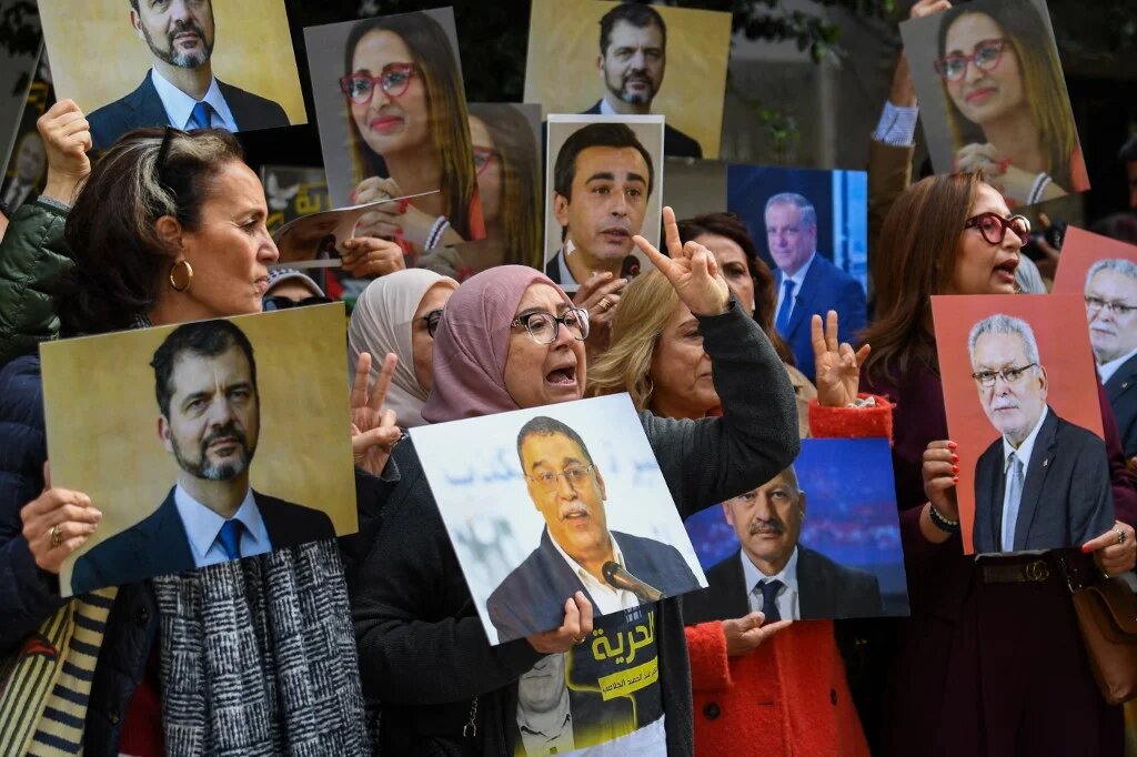 Relatives of detainees accused of involvement in a conspiracy case against state security demonstrate in front of a Tunis court on 4 March (Fethi Balaid/AFP)