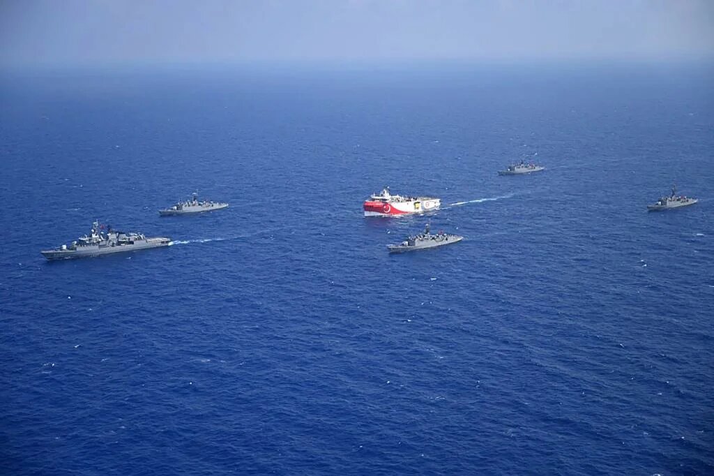 Turkish seismic research vessel 'Oruc Reis' (C) as it is escorted by Turkish Naval ships in the Mediterranean Sea, off Antalya on August 10, 2020.  (Handout / Turkish Defense Ministry)