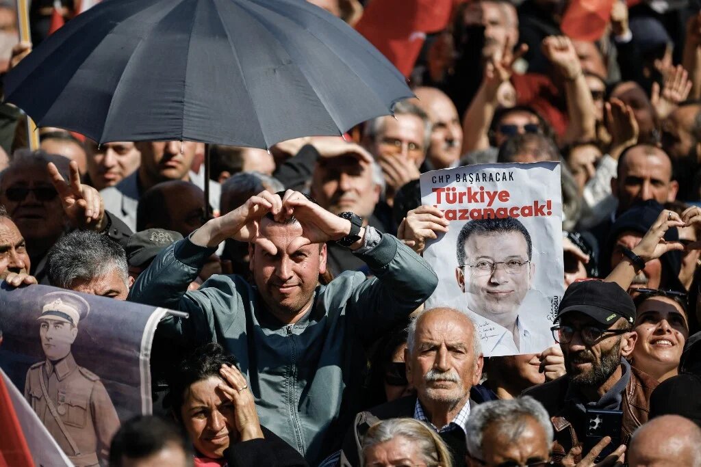 A protester holds a placard depicting the city's mayor Ekrem Imamoglu during a demonstration called by the Republican People's Party (CHP) in support of Istanbul's arrested mayor Ekrem Imanoglu in Maltepe, on the outskirts of Istanbul on March 29, 2025. (KEMAL ASLAN / AFP)