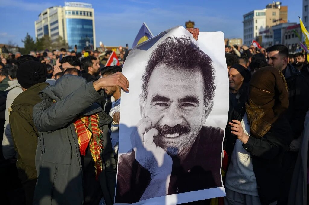 Supporters display a poster depicting jailed leader of the Kurdistan Workers' Party (PKK) Abdullah Ocalan, 75, on February 27, 2025 in Istanbul. (Yasin AKGUL / AFP)