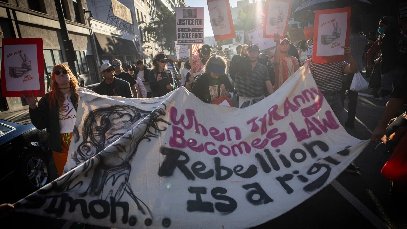 People hold a banner during a protest in Los Angeles, California on 10 January 2026 against US Immigration and Customs Enforcement (ICE) after the fatal shooting of Renee Nicole Good in Minneapolis. ETIENNE LAURENT / AFP