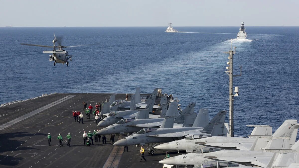 The aircraft carrier USS Abraham Lincoln transits the Strait of Hormuz as a helicopter lifts off from the flight deck, on 19 November 2019 (Stephanie Contreras/US Navy/AFP)