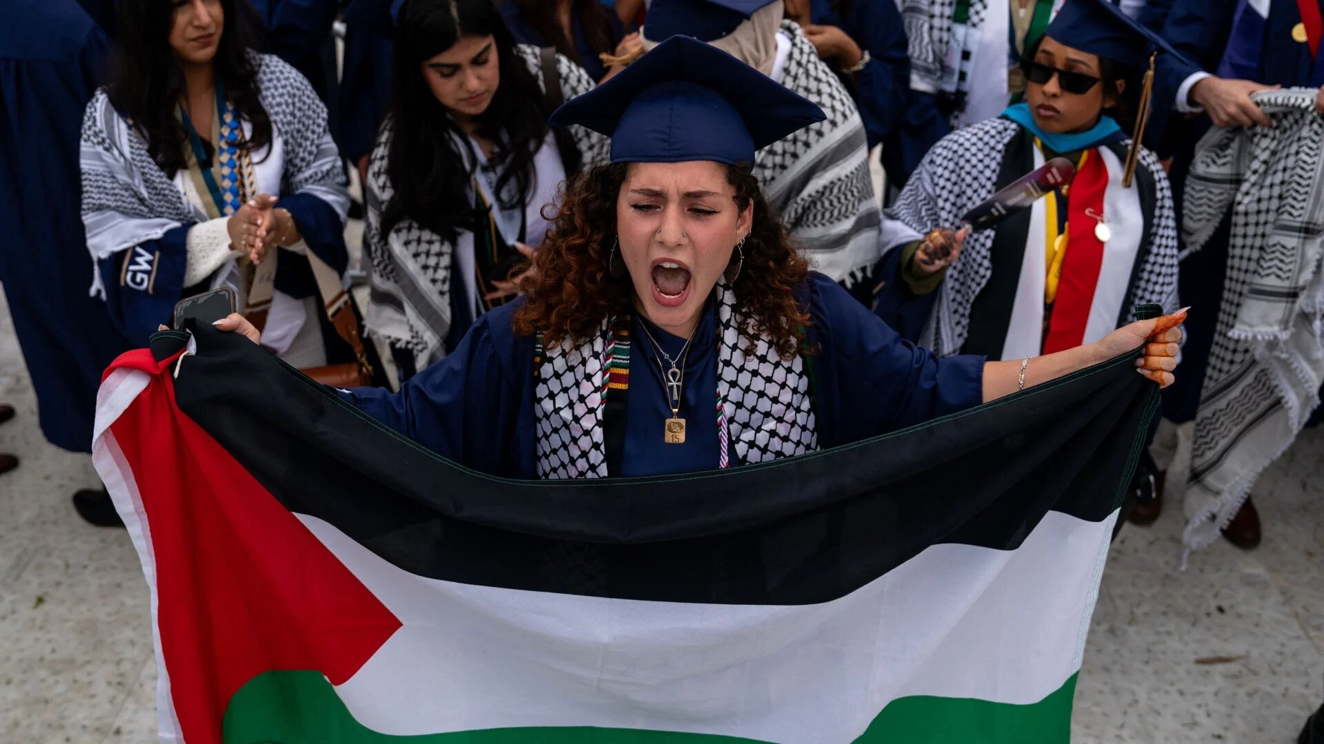 Students protest as they walk out from the George Washington University commencement ceremony on 19 May 2024 in Washington, DC (AFP/Kent Nishimura/Getty Images via AFP)
