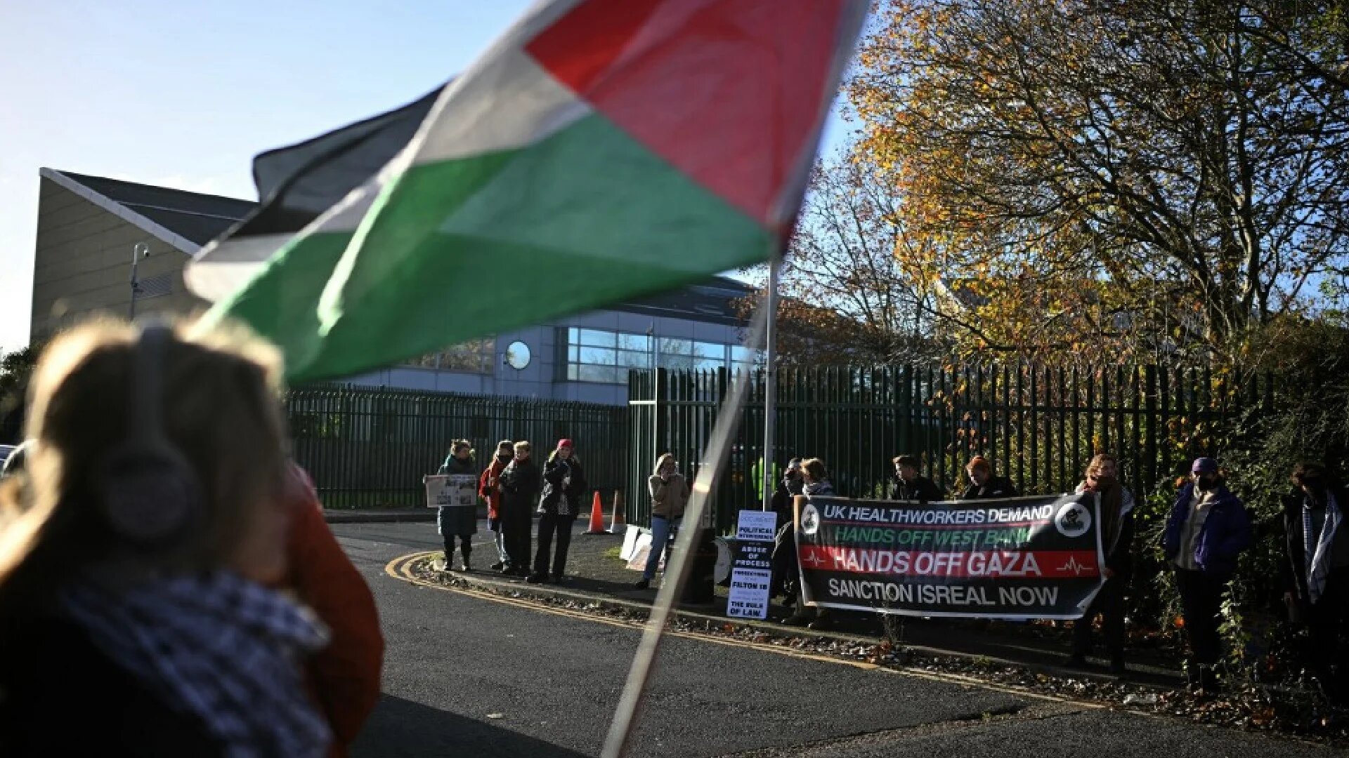 Protesters outside Woolwich Crown Court in London, where alleged Palestine Action activists are on trial (AFP)