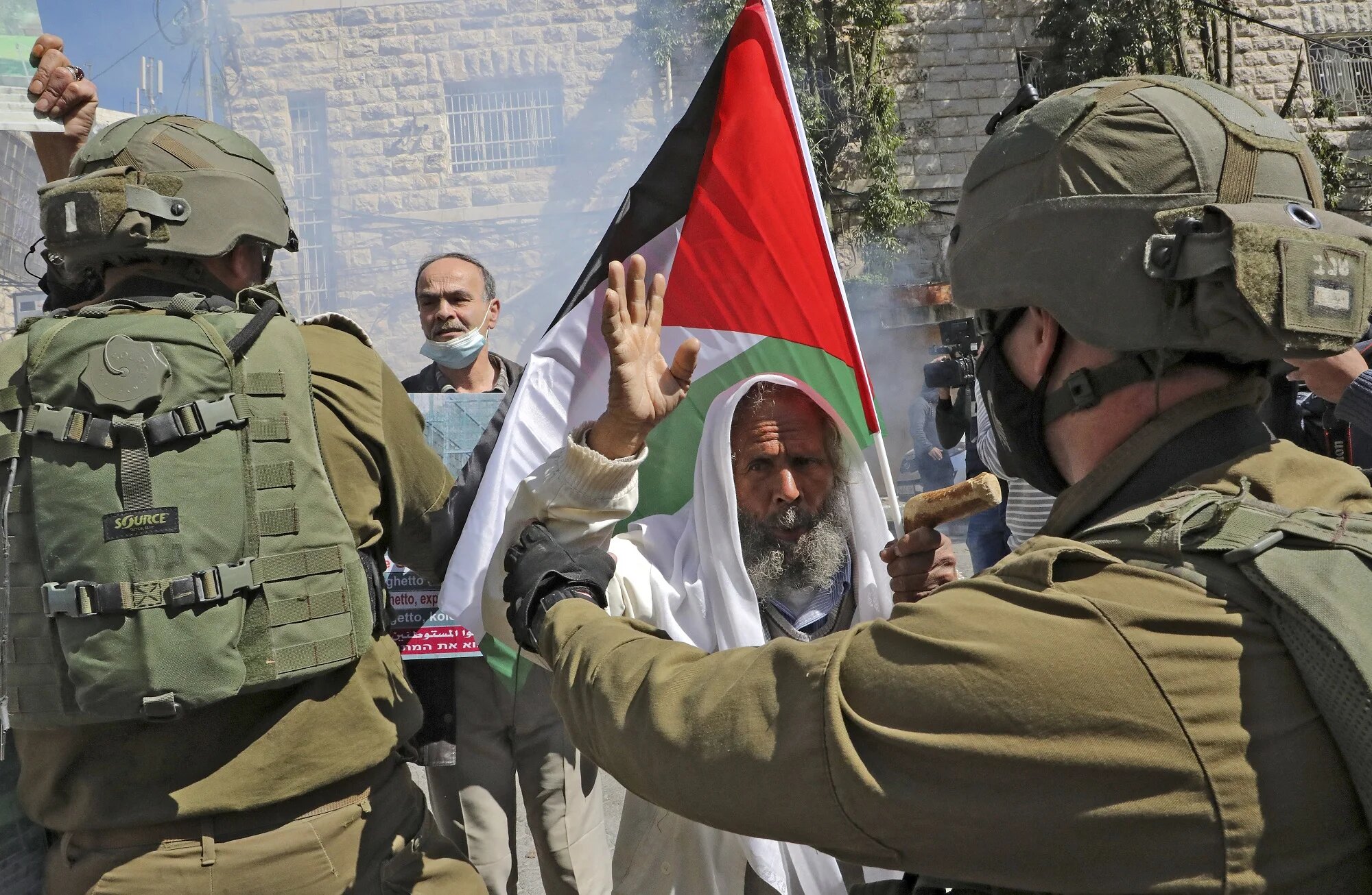 Israeli forces block Palestinian protesters during a demonstration 