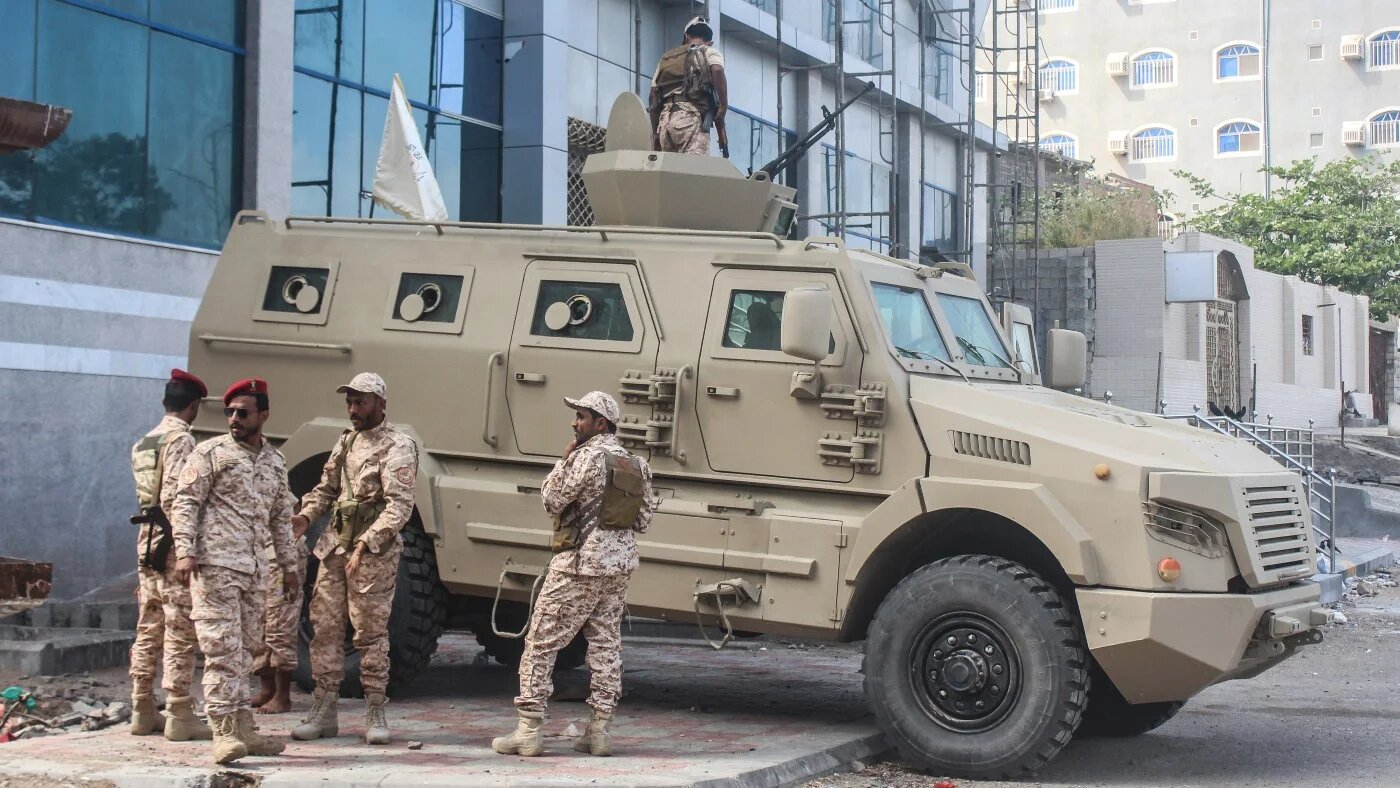 Members of the Southern Giants Brigade stand next to an armoured vehicle deployed in Aden on 7 January 2026. Saleh Al-OBEIDI / AFP
