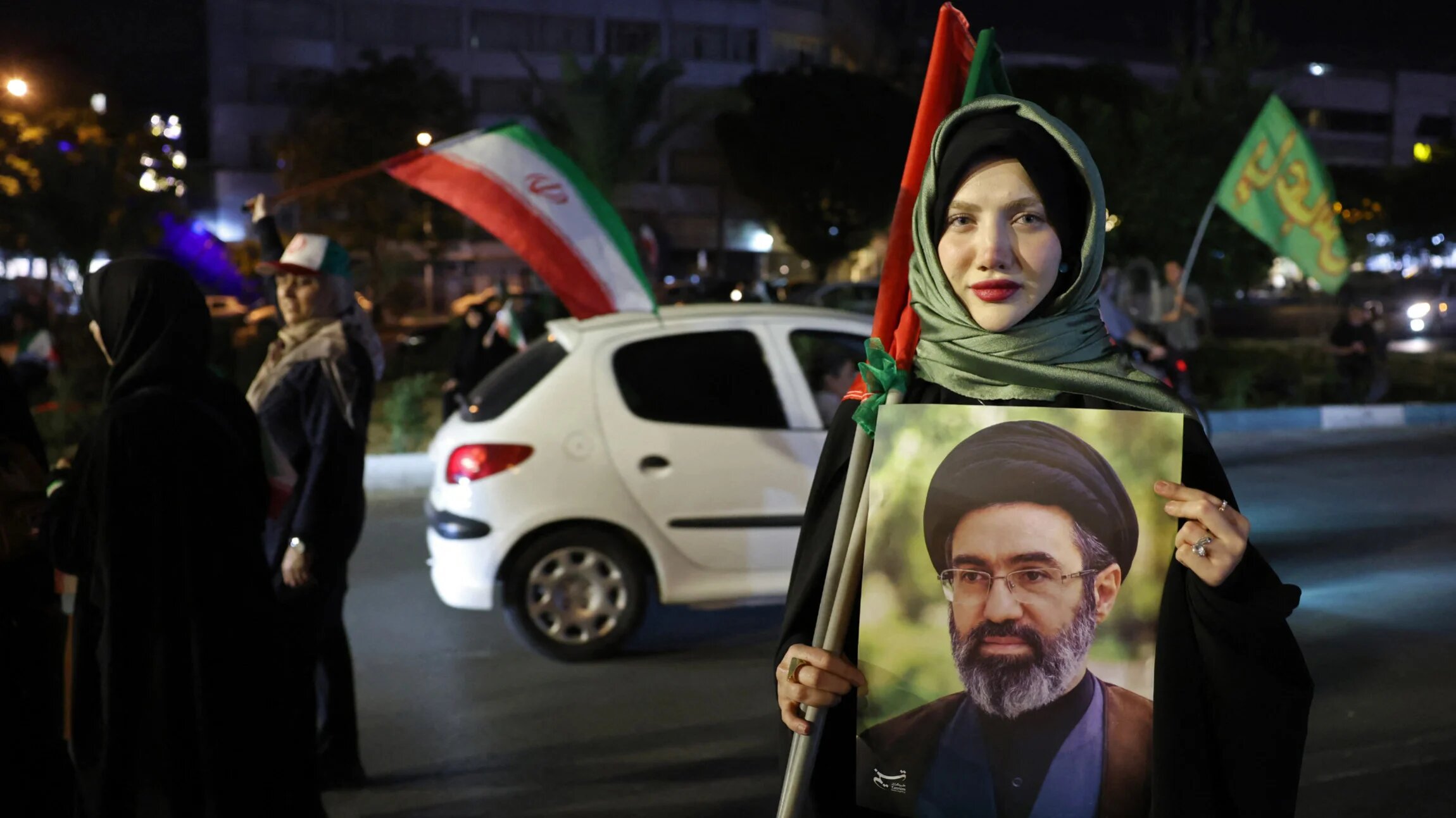 A woman holds a portrait of Iran's supreme leader Ayatollah Mojtaba Khamenei during a rally against the US and Israel in Tehran on 29 May 2026 (AFP)