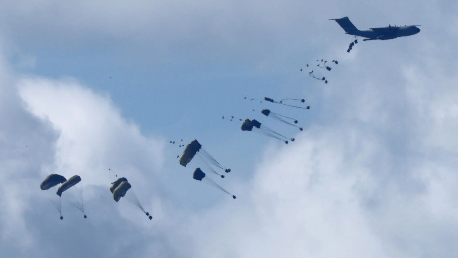 A military plane drops humanitarian aid over northern Gaza on 7 March 2024 (AFP/Jack Guez)