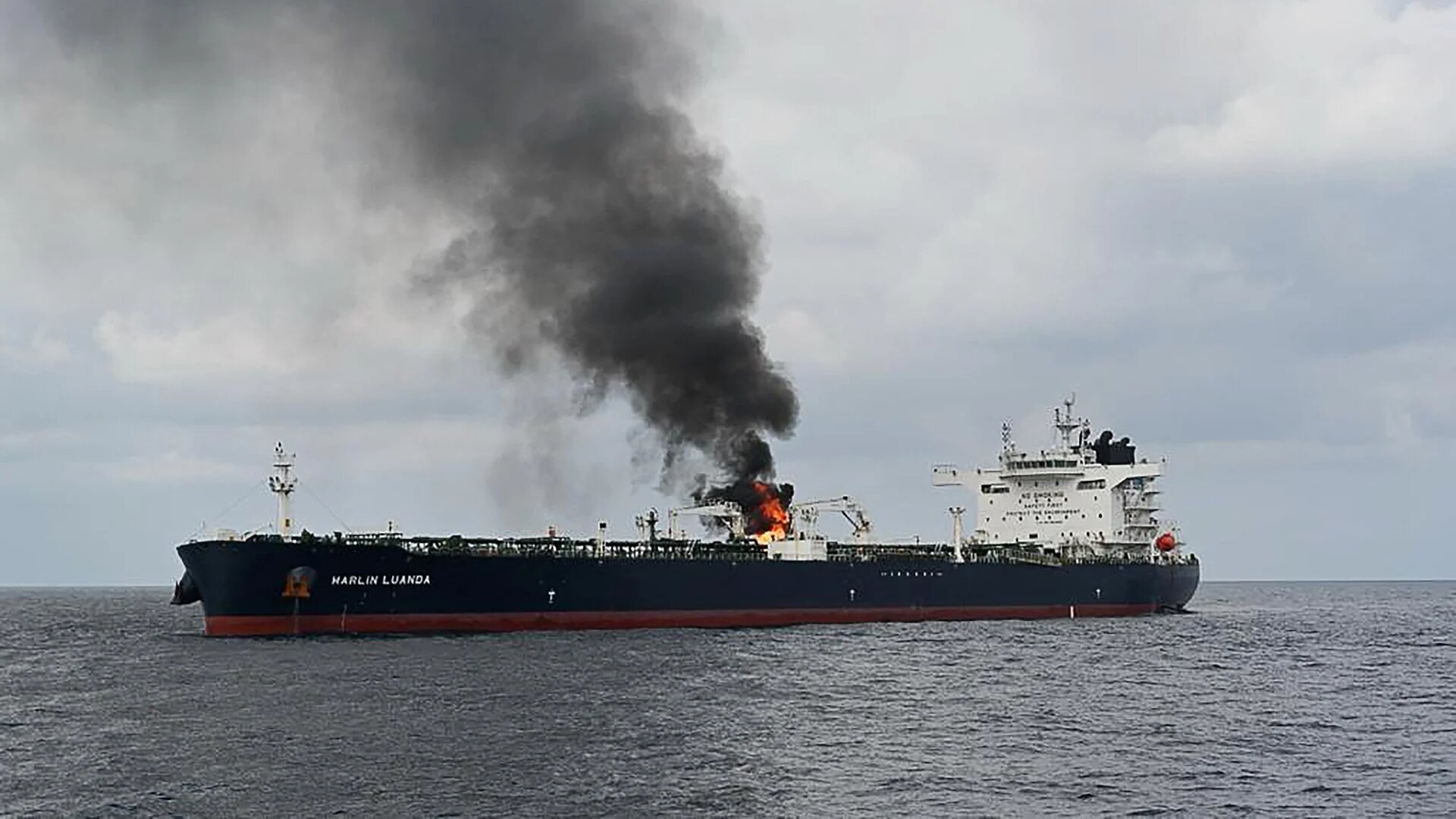 Smoke billows from the British oil tanker MV Marlin Luanda as it transits the Gulf of Aden in the Arabian Sea on 27 January 2024 (AFP/Indian Ministry of Defence)