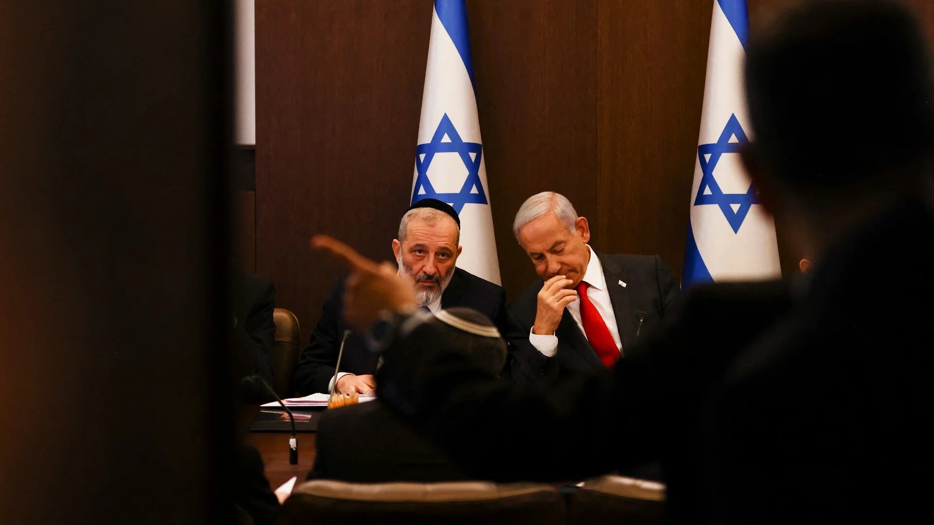 Israel's Prime Minister Benjamin Netanyahu sits next to Interior and Health Minister Aryeh Deri during a weekly cabinet meeting in Jerusalem on 8 January 2023 (AFP)