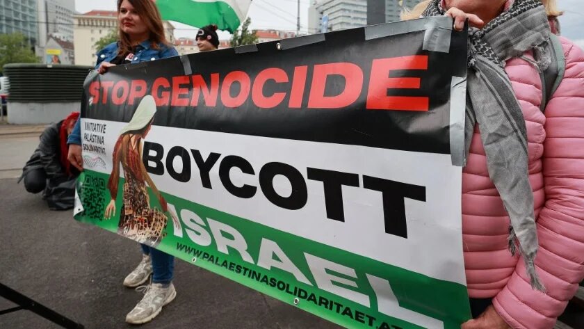 Activists hold a banner to protest against the participation of Israel in the Eurovision Song Contest, in Vienna, Austria, on 12 May 2026 (Radek Mica/AFP)