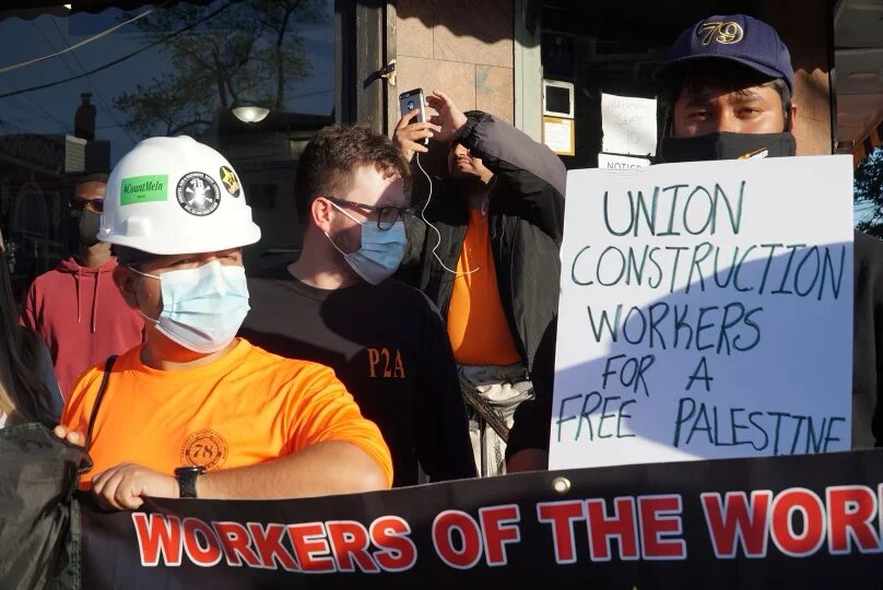 Construction workers hold banners during a protest for Palestine organised by Within Our Lifetime in the Bronx, a borough in New York City.