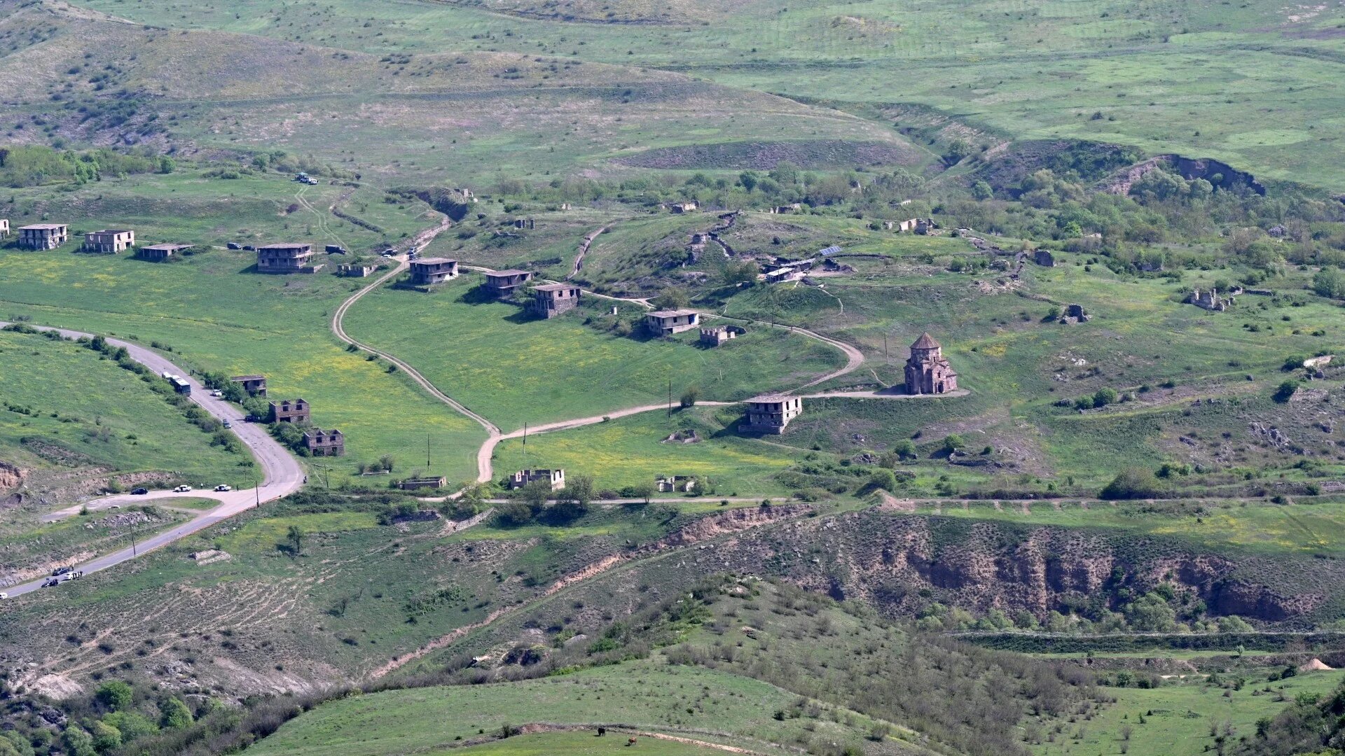 A photograph taken on 26 April 2024 near the border with Azerbaijan shows a view of the Armenian village of Voskepar, in Tavush region, with its Orthodox Holy Mother of God Church (Karen Minasyan/AFP)