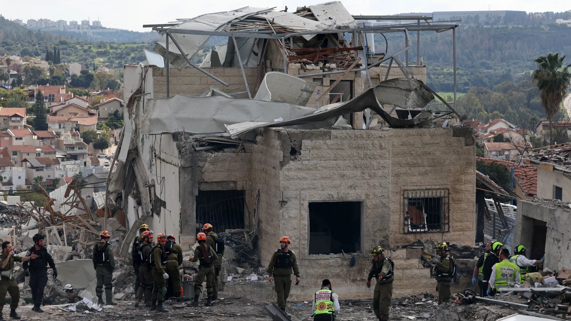 Israeli emergency service officers inspect destroyed house at the scene of a missile attack near Bet Shemesh, some 30 kilometres west of Jerusalem on 1 March 2026 (AFP/Ahmad Gharabli)