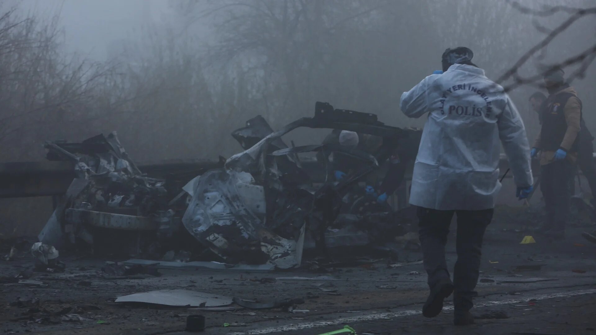 Police forensic experts examine the site after a bomb exploded in a roadside vehicle while a police minibus passed by in Diyarbakir, Turkey on 16 December 2022 (Reuters)