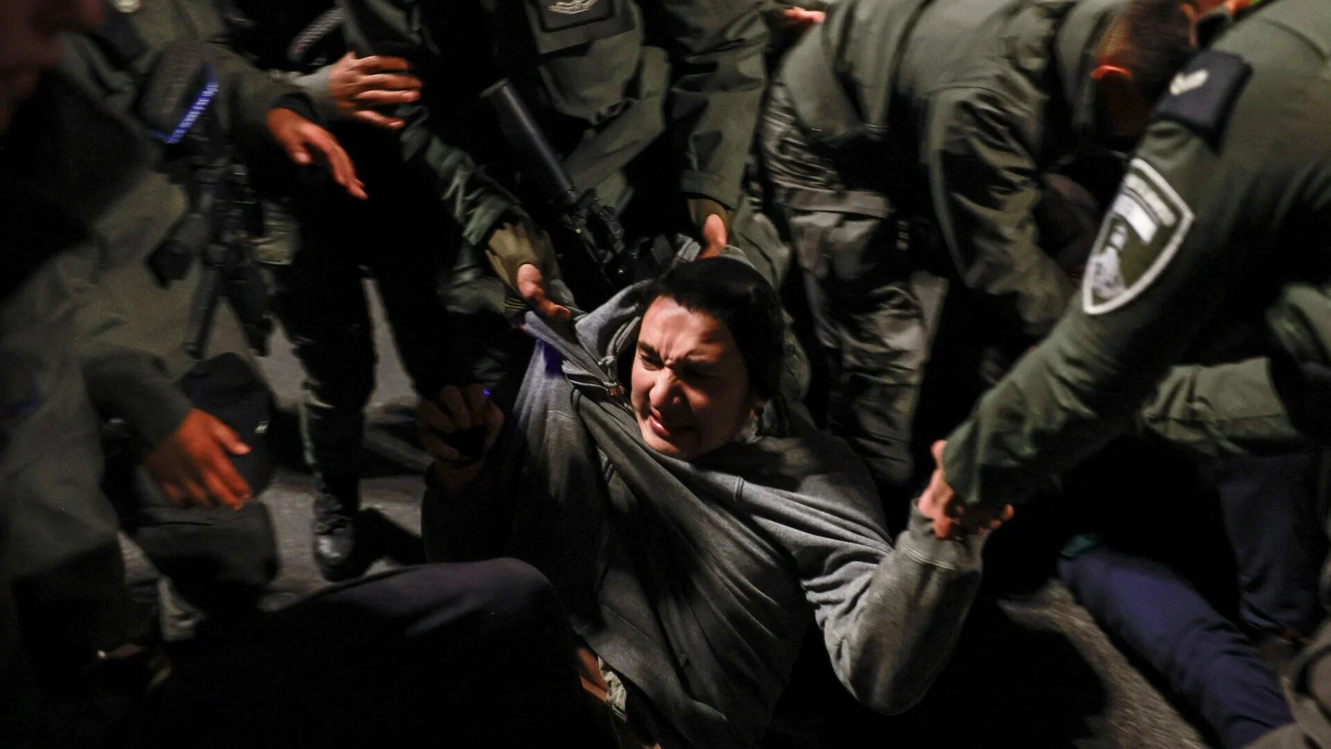 Police officers pull a demonstrator as Israelis protest the Gaza ceasefire deal, in Jerusalem, 16 January (Reuters/Ammar Awad)