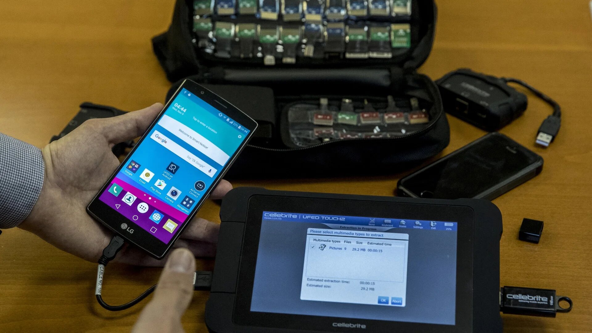 An engineer shows devices and explains the technology developed by the Israeli firm Cellebrite on 9 November 2016 (AFP)