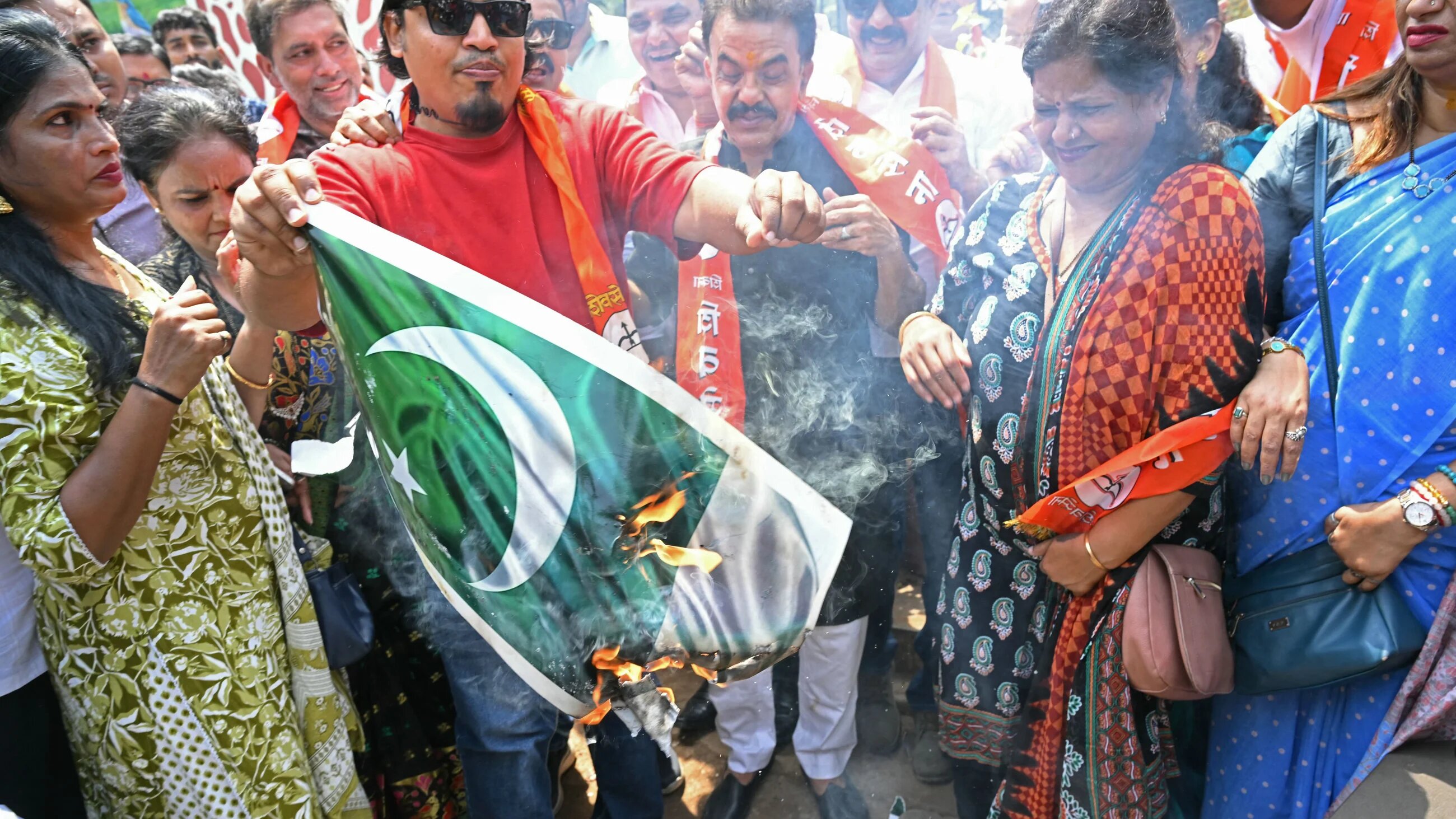 Activists of the right-wing Shiv Sena political party burn a poster of Pakistan's national flag during a protest in Mumbai on 23 April 2025 to condemn the Kashmir tourist attack (Indranil MUKHERJEE / AFP)