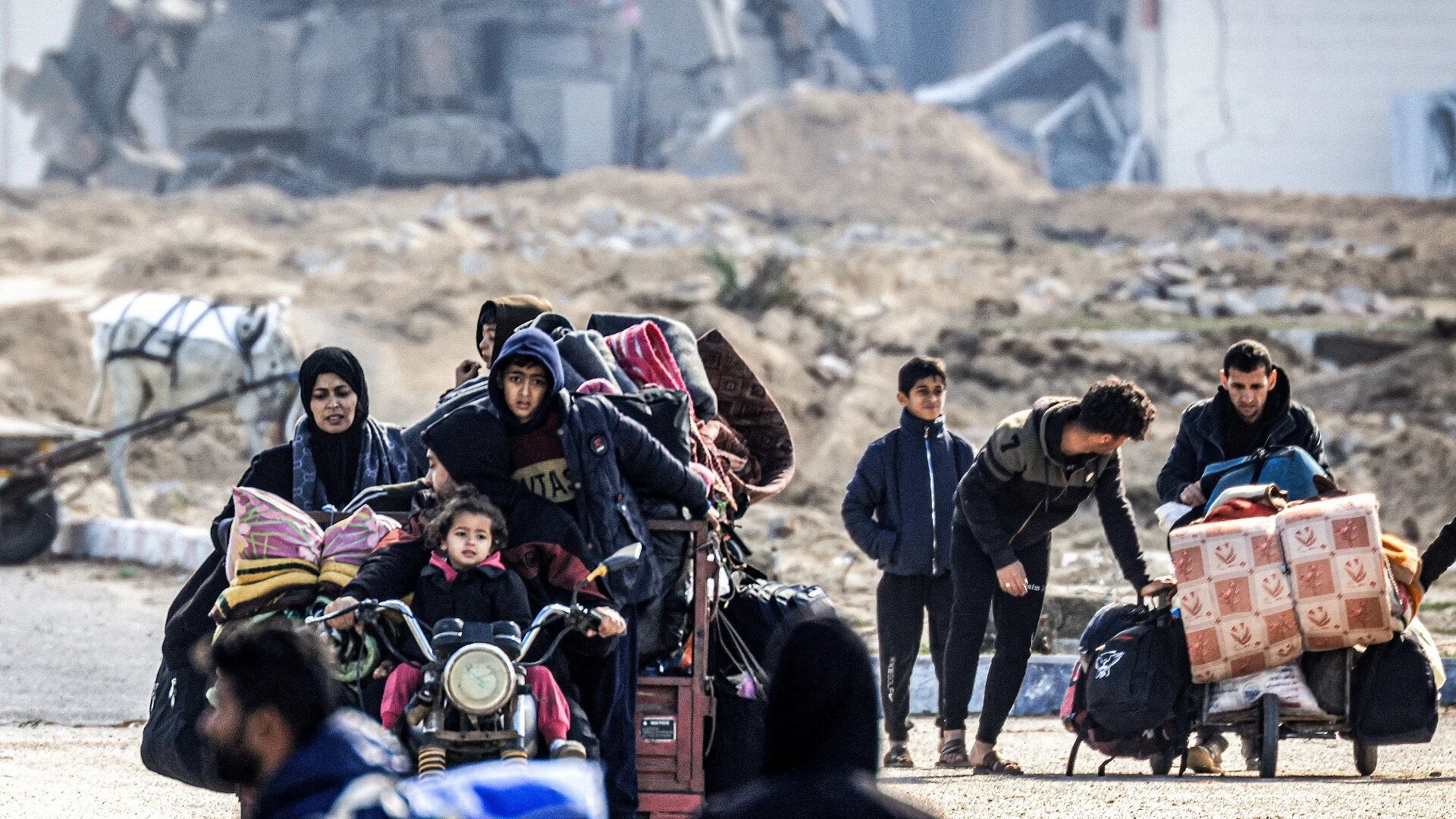 Displaced Palestinians flee from Khan Younis in the southern Gaza Strip on 30 January 2024 (Mahmud Hams/AFP)