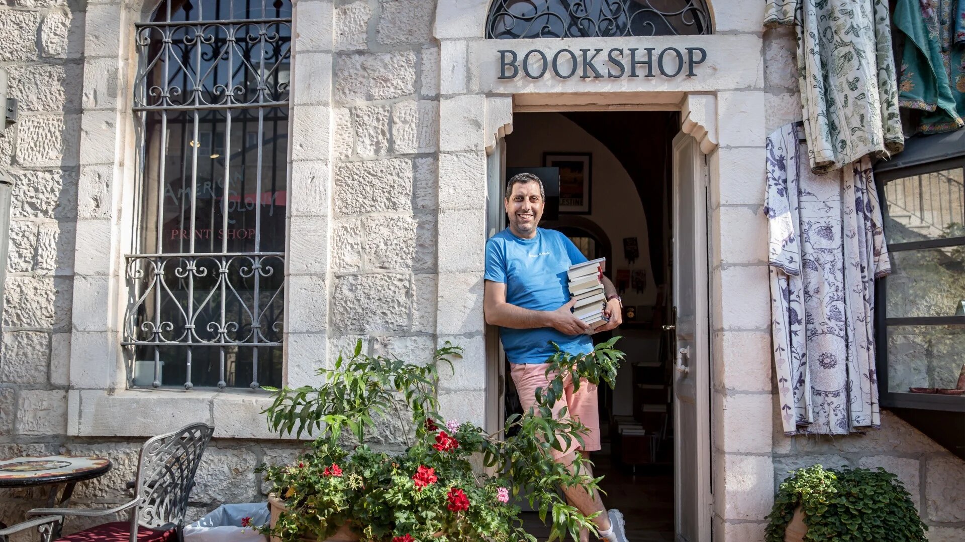Mahmoud Muna, one of the owners of East Jerusalem's Educational Bookshop, seen outside a branch of the store (Reuters)