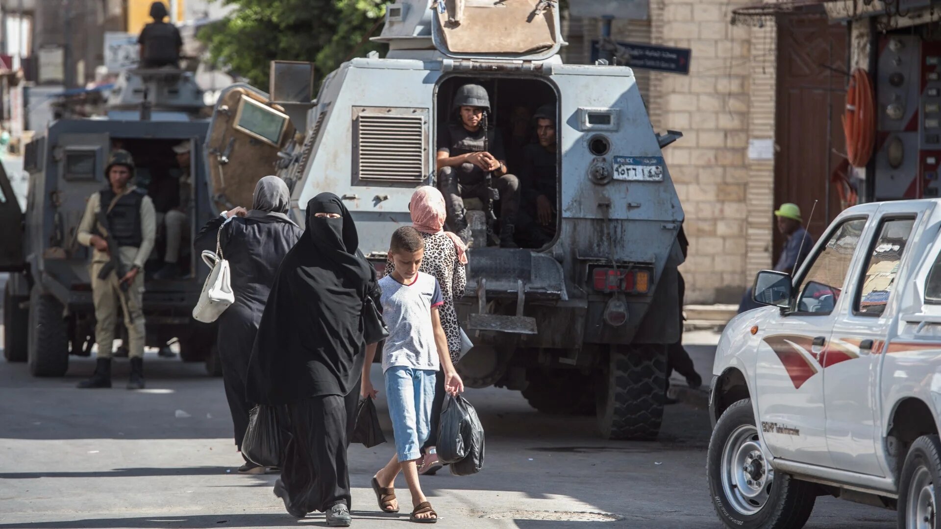 A picture taken on 26 July 2018 shows Egyptian policemen stand guarding a street in the North Sinai provincial capital of El-Arish (AFP)