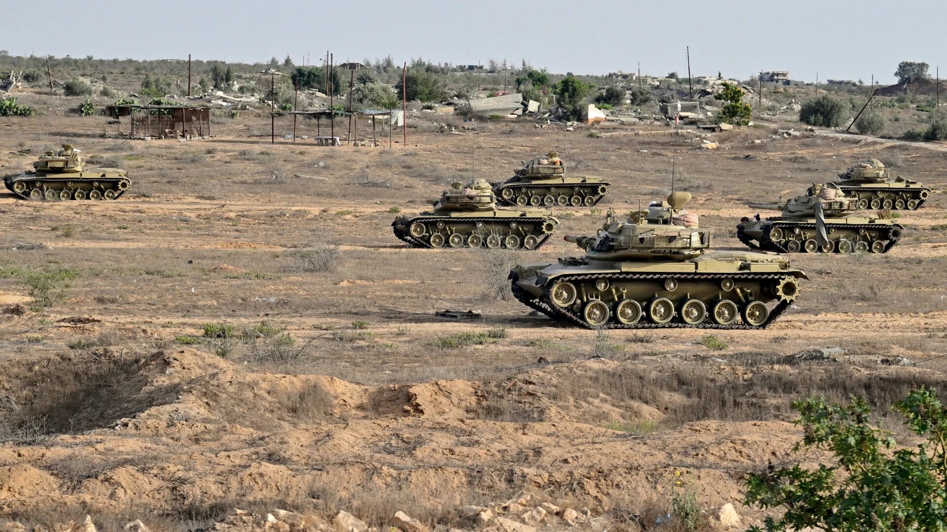 Egyptian army tanks deployed along the border with the Gaza Strip on 4 July 2024 in el-Arish, in the north Sinai Peninsula (AFP)