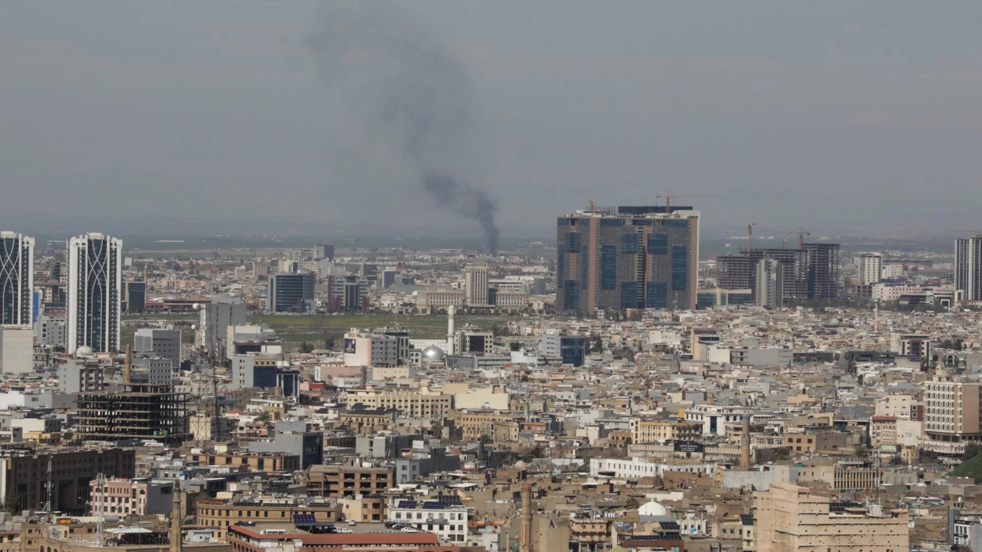 A plume of smoke rises following an interception of a drone in Erbil on 12 March 2026 (AFP/Shvan Harki)