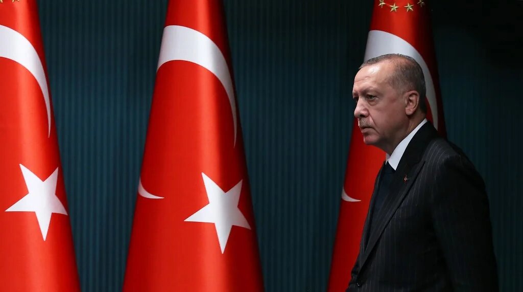 President Recep Tayyip Erdogan arrives for a news conference in Ankara