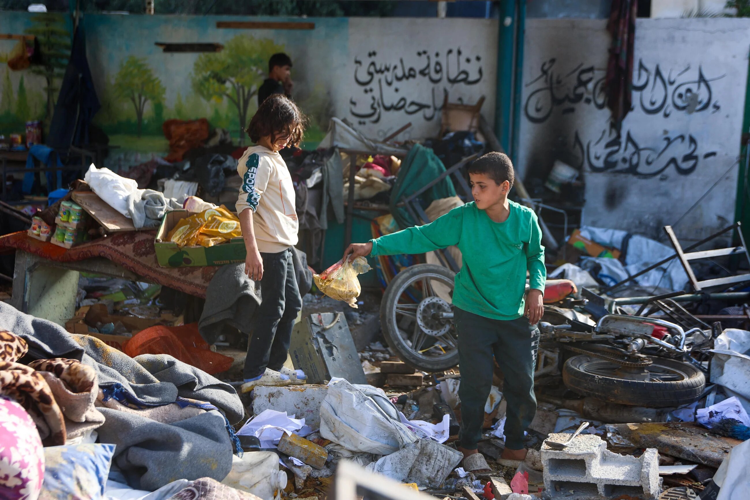 Palestinian children search through the rubble at the Fahmi Al-Jarjawi School in Gaza City on 26 May 26, 2025, following an Israeli strike that killed dozens, including children (AFP/Omar Al-Qattaa)
