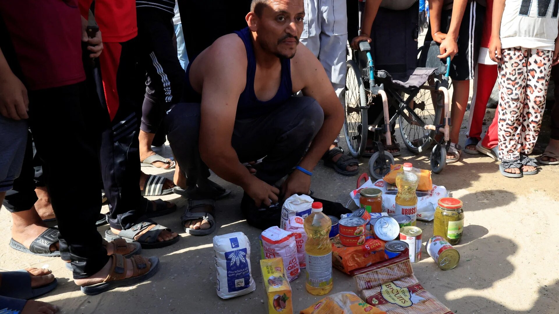 A Palestinian man shows the food supplies he received as part of a box distributed by the Gaza Humanitarian Foundation in Rafah, southern Gaza, on 27 May 2025 (Hatem Khaled/Reuters)