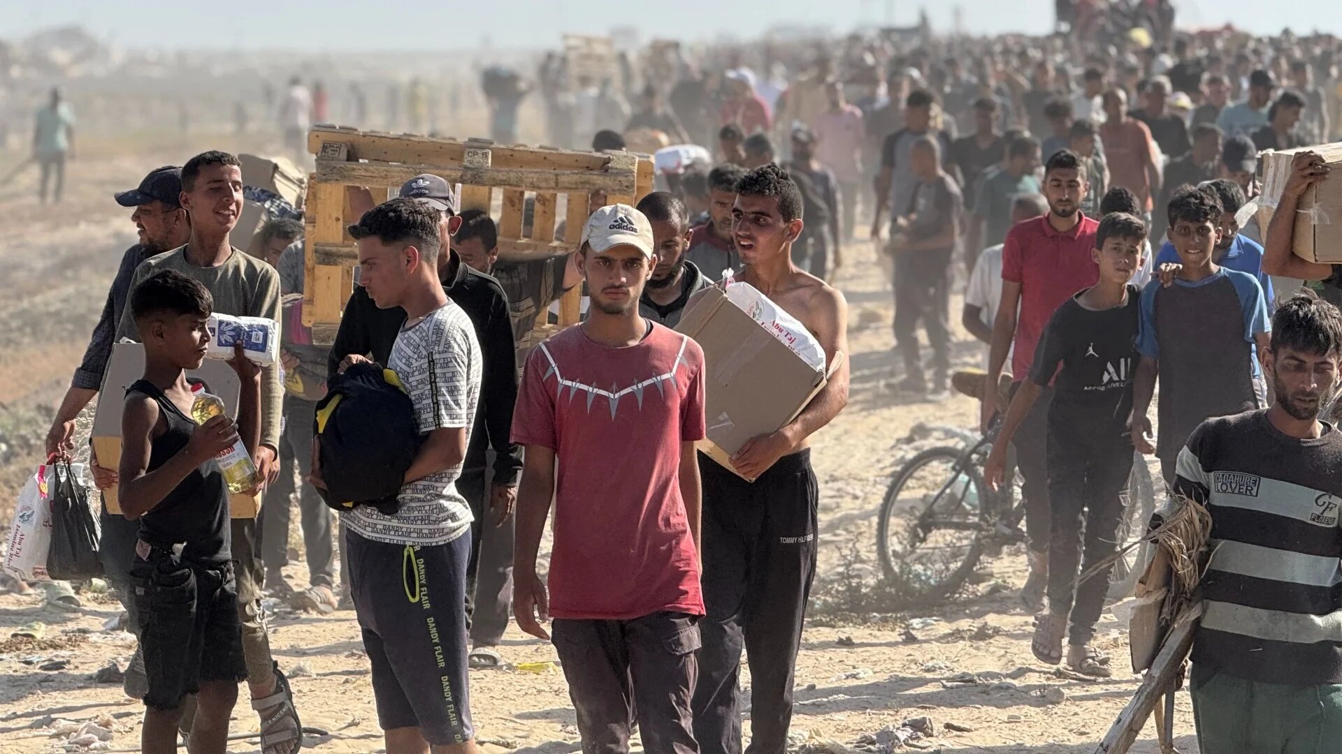 Displaced Palestinians receive food packages from a US-backed foundation in western Rafah in the southern Gaza Strip on 27 May 2025 (AFP)