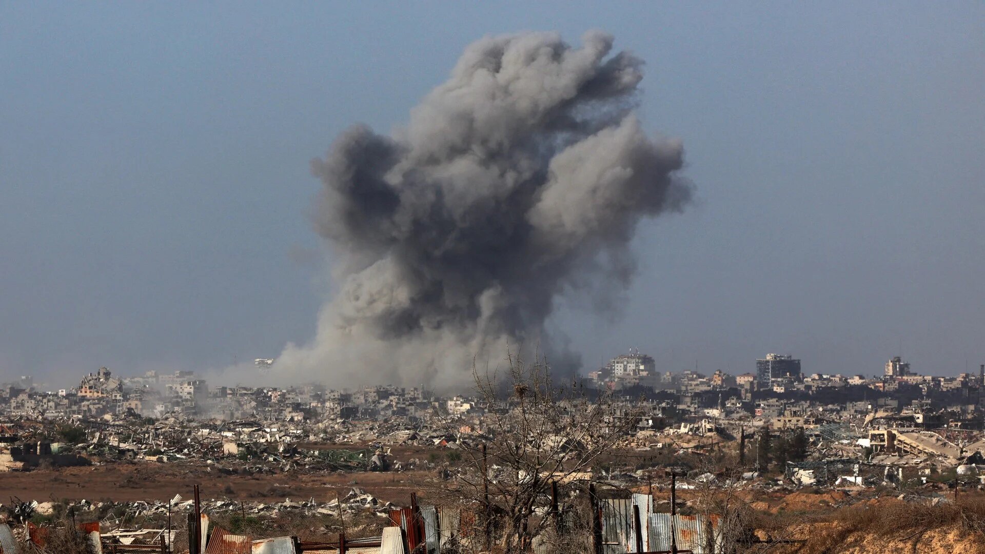 A plume of smoke rises above Gaza City on 3 October 2025 after an Israeli air strike (Jack Guez/AFP)